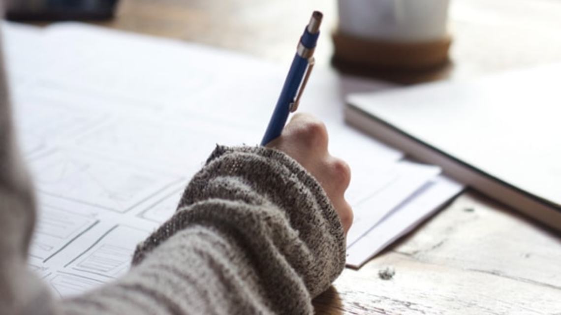 Woman writing in notebook